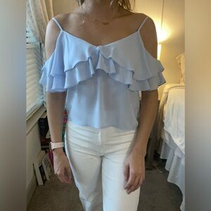 Light blue tank top with ruffled lining and cut out shoulders